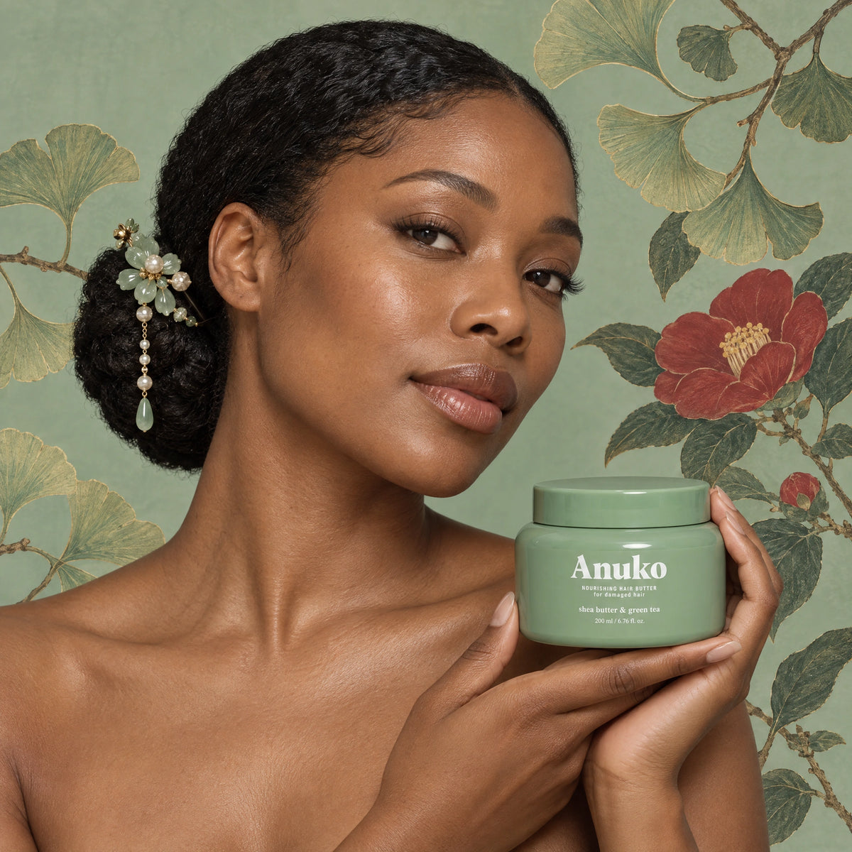 Woman with sleek coily hair holding the Anuko Hair Butter jar