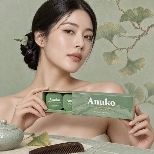 Woman with a jade-pin knot holding the Anuko Travel Hair Butter case