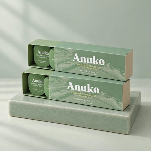 Two Anuko Travel Hair Butter cases stacked on a celadon tile plinth