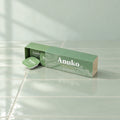 Anuko Travel Hair Butter case with capsules on celadon tile